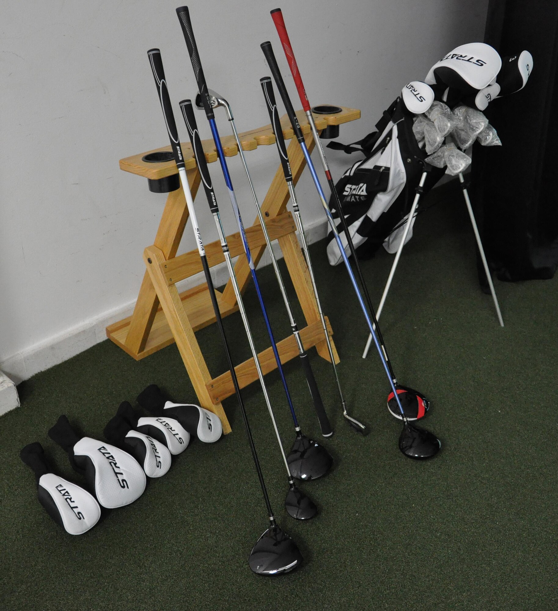 Golf clubs, pictured here, are set up inside the Blatchford Preston Complex Community Activity Center at Al Udeid Air Base, Qatar, Jan. 16. The clubs are available for people to use with the new high definition golf simulator, a virtual golfing experience. The simulator offers golfers several different game modes including a competition mode, where users can play golf versions of tic-tac-toe and Poker. (U.S. Air Force photo by Tech. Sgt. James Hodgman)