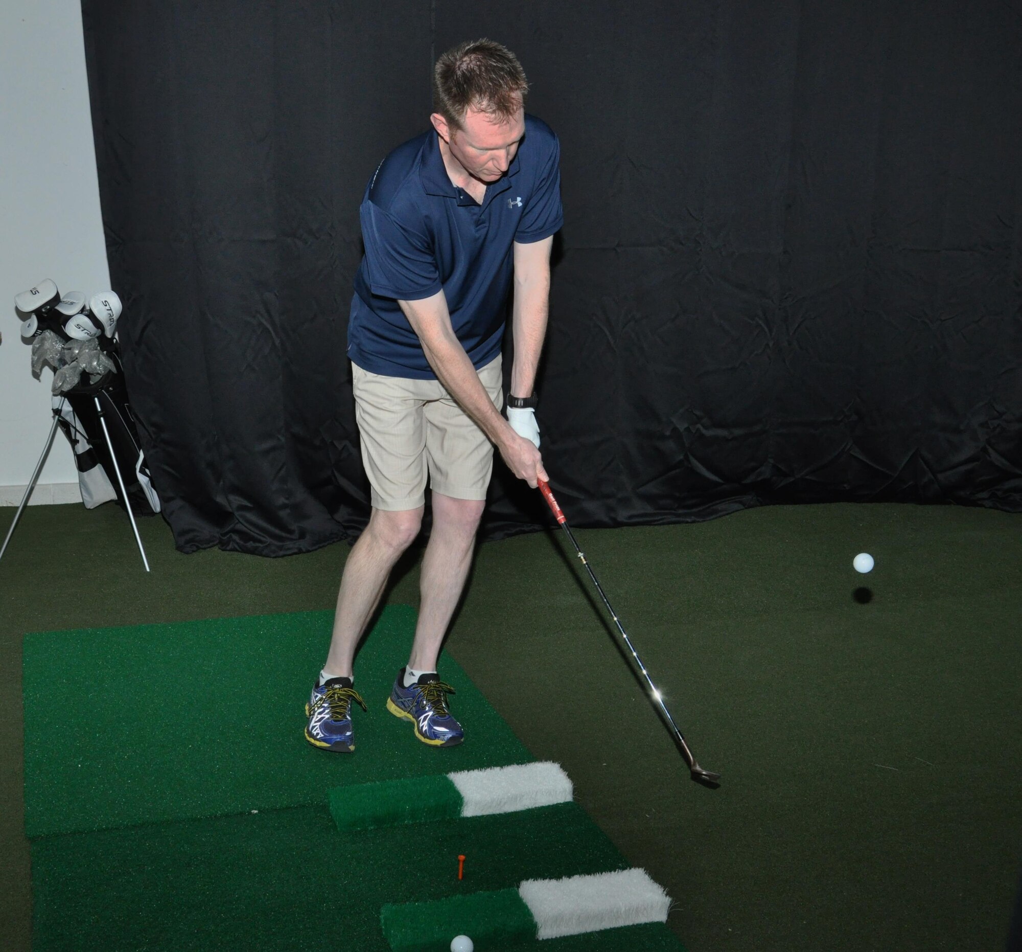 Col. Stuart Newberry, 379th Air Expeditionary Wing vice commander, hits a golf ball into the screen of the high definition golf simulator inside the Blatchford Preston Complex Community Activity Center at Al Udeid Air Base, Qatar, Jan. 16. Newberry, an avid golfer, said the simulator’s graphics were amazing. The simulator offers practice and competition modes, as well as one-on-one instruction from a virtual golf coach. (U.S. Air Force photo by Tech. Sgt. James Hodgman)