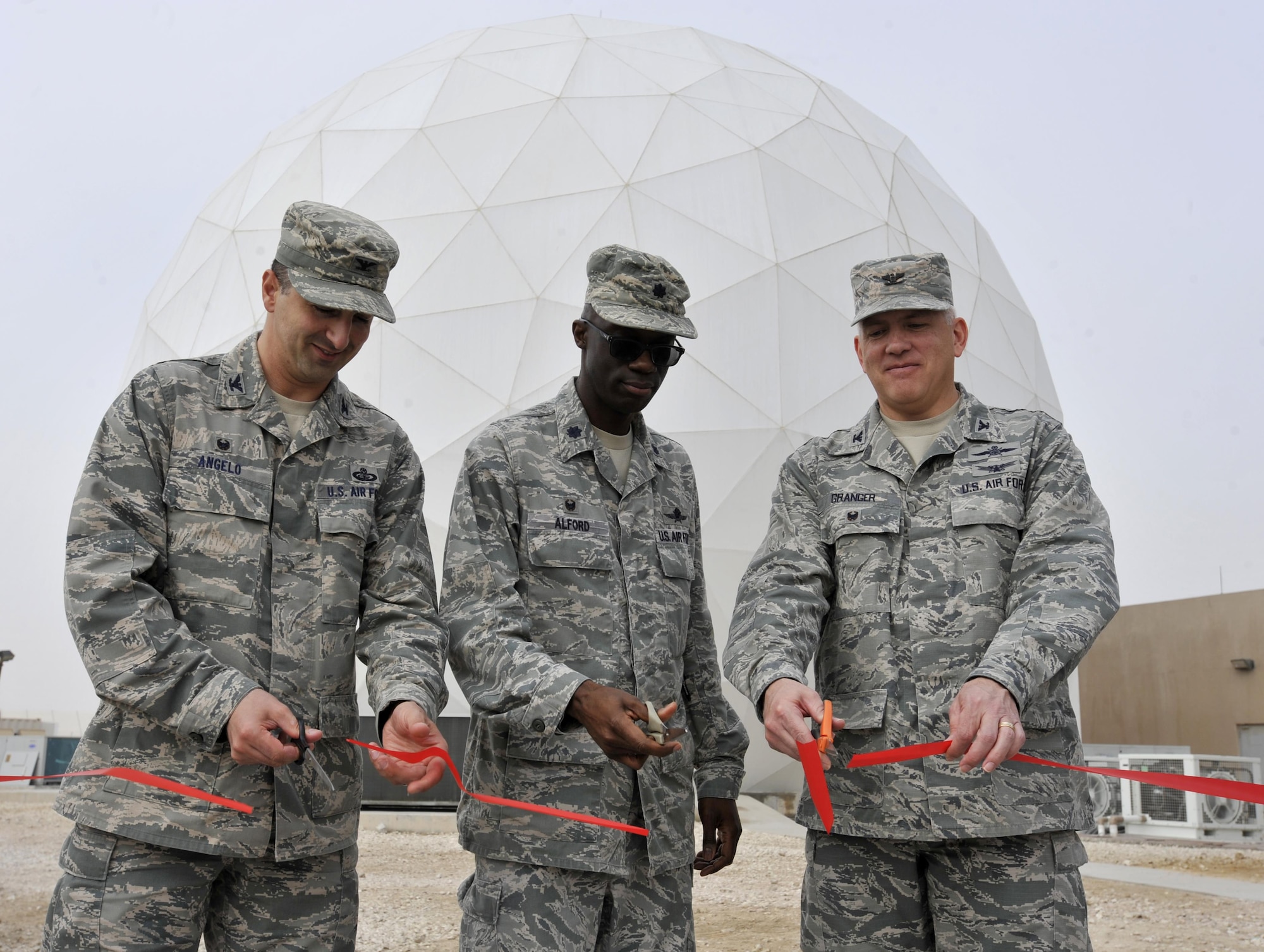 Col. Thomas Angelo, 379th Expeditionary Mission Support Group commander, Lt. Col. Carlos Alford, 379th Expeditionary Communications Squadron commander, and Col. Jeffrey Granger, United States Air Forces Central Command Forward Director of Cyber Forces, cut a ribbon signifying completion of the Modernized Enterprise Terminal at Al Udeid Air Base, Qatar, Jan. 21, 2016.The 379 ECS recently completed an upgrade to their Army, Navy Ground Satellite Communications system which will enable better communications for warfighters. (U.S. Air Force photo by Master Sgt. Joshua Strang)