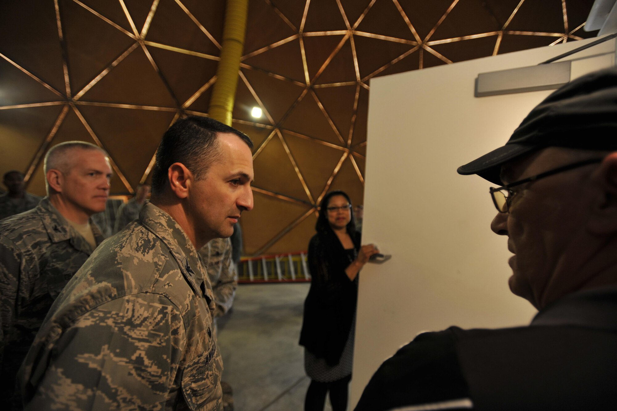 Thomas Butterworth, 379th Expeditionary Communications Squadron Satellite Communications Lead, briefs Col. Thomas Angelo, 379th Expeditionary Mission Support Group commander and Col. Jeffrey Granger, United States Air Forces Central Command Forward Director of Cyber Forces, about the Modernized Enterprise Terminal at Al Udeid Air Base, Qatar, Jan. 21, 2016. The 379 ECS recently completed an upgrade to their Army, Navy Ground Satellite Communications system which will enable better communications for warfighters. (U.S. Air Force photo by Master Sgt. Joshua Strang)