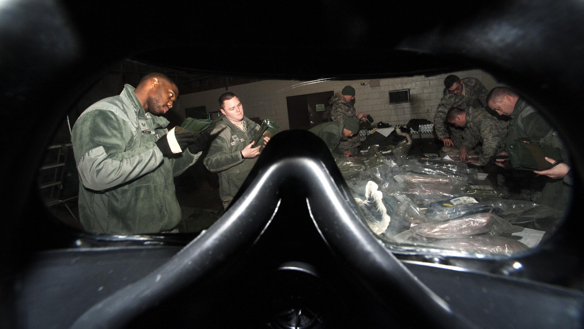 Airmen from the 8th Logistics Readiness Squadron issue individual protection equipment to newly assigned Airmen at Kunsan Air Base, Republic of Korea, Jan. 15, 2016. The 8th LRS IPE Airmen provide More than 260 IPE kits are issued monthly to Airmen, ensuring that each member has the correct equipment to protect themselves in the event that a contingency does rise. (U.S. Air Force photo by Staff Sgt Nicholas Wilson/Released)