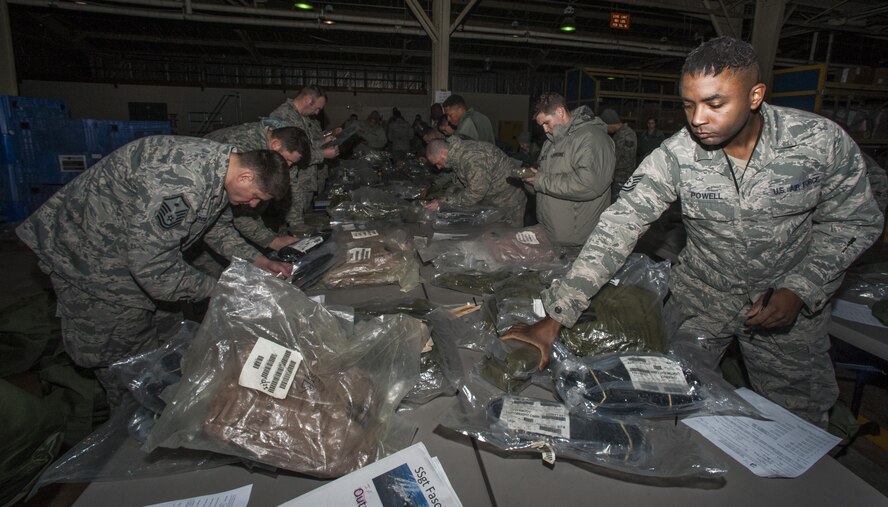 Airmen from the 8th Logistics Readiness Squadron issue individual protection equipment to newly assigned Airmen at Kunsan Air Base, Republic of Korea, Jan. 15, 2016. The 8th LRS IPE Airmen provide More than 260 IPE kits are issued monthly to Airmen, ensuring that each member has the correct equipment to protect themselves in the event that a contingency does rise. (U.S. Air Force photo by Staff Sgt Nicholas Wilson/Released)