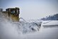 An Airman from the 51st Civil Engineer Squadron uses a runway sweeper truck to remove the first snow of the year on the flightline behind the Air Mobility Command passenger terminal Jan. 13, 2016, at Osan Air Base, South Korea. Airmen remove snow from the runways, taxiways and flightline to ensure passenger and aircraft safety. The runway sweeper head is approximately 20-feet wide, which helps reduce the amount of time it takes to completely clear the flightline of snow. (U.S. Air Force photo/Tech. Sgt. Travis Edwards)