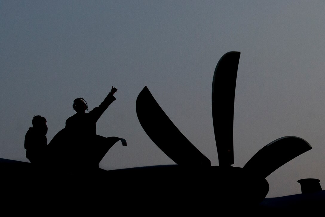 Tech. Sgt. Matthew Beck, of the 455th Expeditionary Aircraft Maintenance Squadron, gives a thumbs-up from the wing of a C-130 Hercules after running an engine test at Bagram Airfield, Afghanistan, Jan. 12, 2016. The 455th EAMXS ensures aircraft are prepared for flight and return them to a mission-ready state once they land. (U.S. Air Force photo/Tech. Sgt. Robert Cloys)