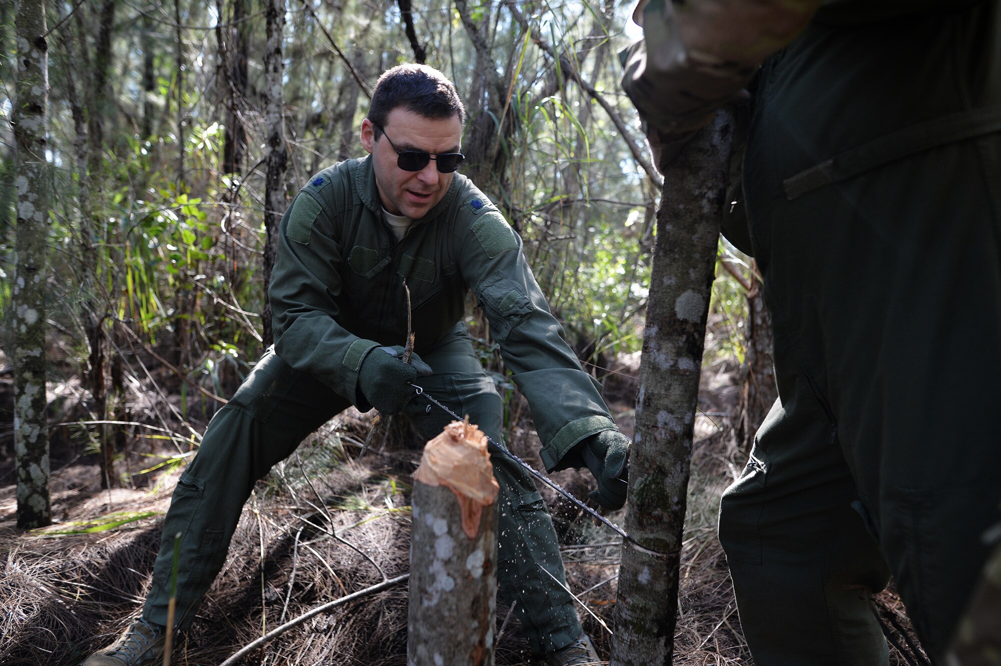 Lt. Col. Scott Stenger, a member of the 106th Rescue Wing, practices using a handheld saw during a combat and water survival training course at Homestead Air Reserve Base, Fla., Jan. 18, 2016. During the training, aircrew members gained refresher training on using their emergency radios, tactical movements through difficult terrain, how to build shelters, ways to build fires, and methods for evading the enemy. (U.S. Air National Guard photo/Staff Sgt. Christopher S. Muncy)