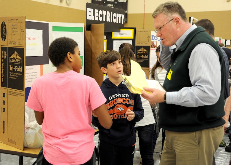 Michael O’Sullivan, U.S. Army Corps of Engineers, Huntsville Control Management Branch, judges Franklin Johnson and Mason Hart, fifth graders, on their electric fruit presentation during the Challenger Elementary School Science Fair Jan. 20. The students discovered that seven lemons power a .5 volt LED.