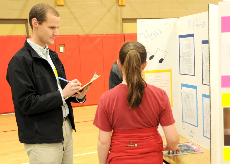 John Nevels, a structural engineer with the Engineering and Support Center, Huntsville judges Lydia Fairchild's "How Music Affects Our Bodies" fifth grade science fair project during the Challenger Elementary School Science Fair Jan. 20.