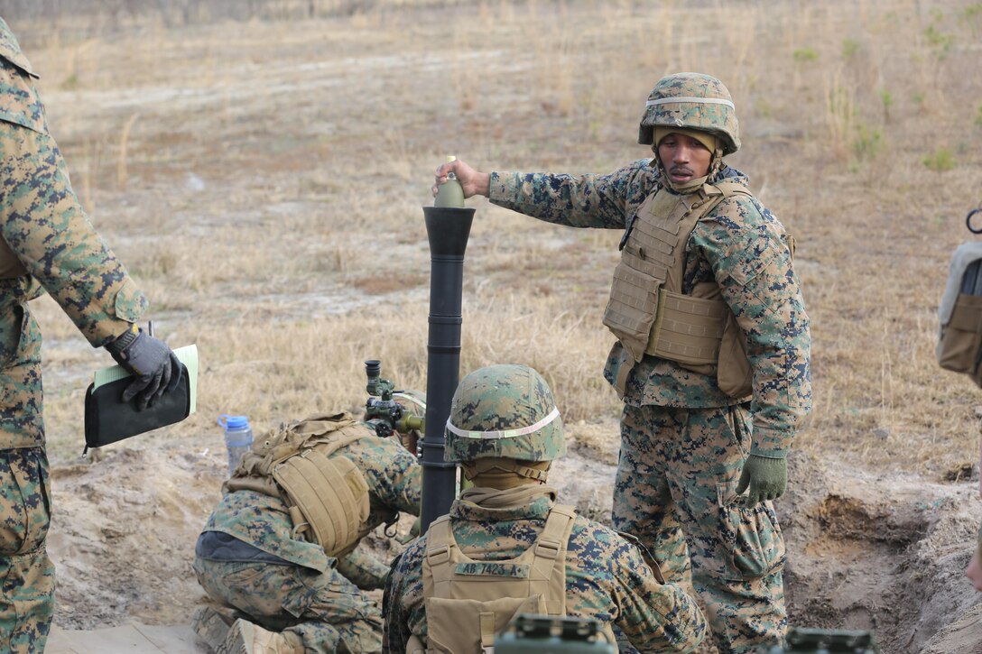Lance Cpl. Brandon Hopkins, a mortarman with 2nd Battalion, 2nd Marine Regiment,  awaits for the command to load and fire during a live-fire mortar exercise with 81 mm mortar systems in preparation for the unit’s upcoming deployment at Camp Lejeune, N.C., Jan. 21. The Marines worked with the mortar systems until the late evening, sending more than 350 rounds downrange, and accomplished their goal of having more than 90 percent of their rounds impact on their designated targets. (U.S. Marine Corps photo by Cpl. Shannon Kroening/ Released)