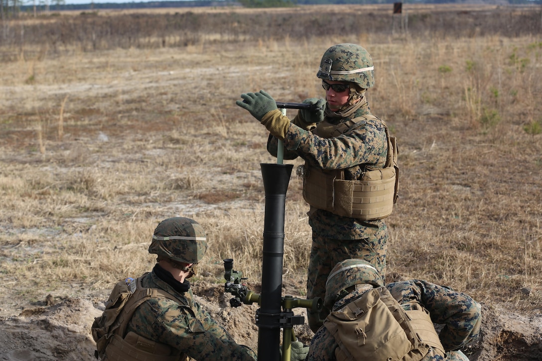 Private First Class Austin Brooks, a mortarman with 2nd Battalion, 2nd Marine Regiment, clears his crew’s gun of debris after firing  during a live-fire mortar exercise with 81 mm mortar systems in preparation for the unit’s upcoming deployment at Camp Lejeune, N.C., Jan. 21. The Marines worked with the mortar systems until the late evening, sending more than 350 rounds downrange, and accomplished their goal of having more than 90 percent of their rounds impact on their designated targets. (U.S. Marine Corps photo by Cpl. Shannon Kroening/ Released)