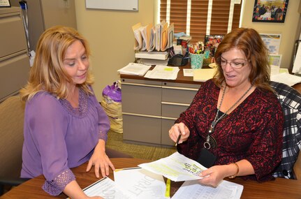 Renee Burek (left) discusses the 1105 career series program with Kim Wentrcek at the Mission and Installation Contracting Command on Joint Base San Antonio-Fort Sam Houston. Burek is the 1105 program coordinator for the MICC and Wentrcek is chief of business operations for the MICC Contracting Operations Directorate.