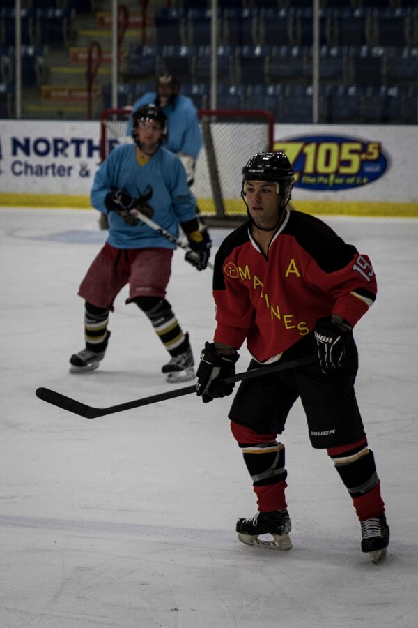 Sergeant Thomas Adams prepares to receive a pass during The Maine Event, Battle on Ice hockey tournament, Jan. 15. Adams is one of 15 Marines who came together from across the country to play in the tournament. This is the first time the team has played together and is aiming to create a Marine Corps-recognized All-Marine Ice Hockey Team. Adams is a satellite communications operator with the 3rd Marine Regiment.