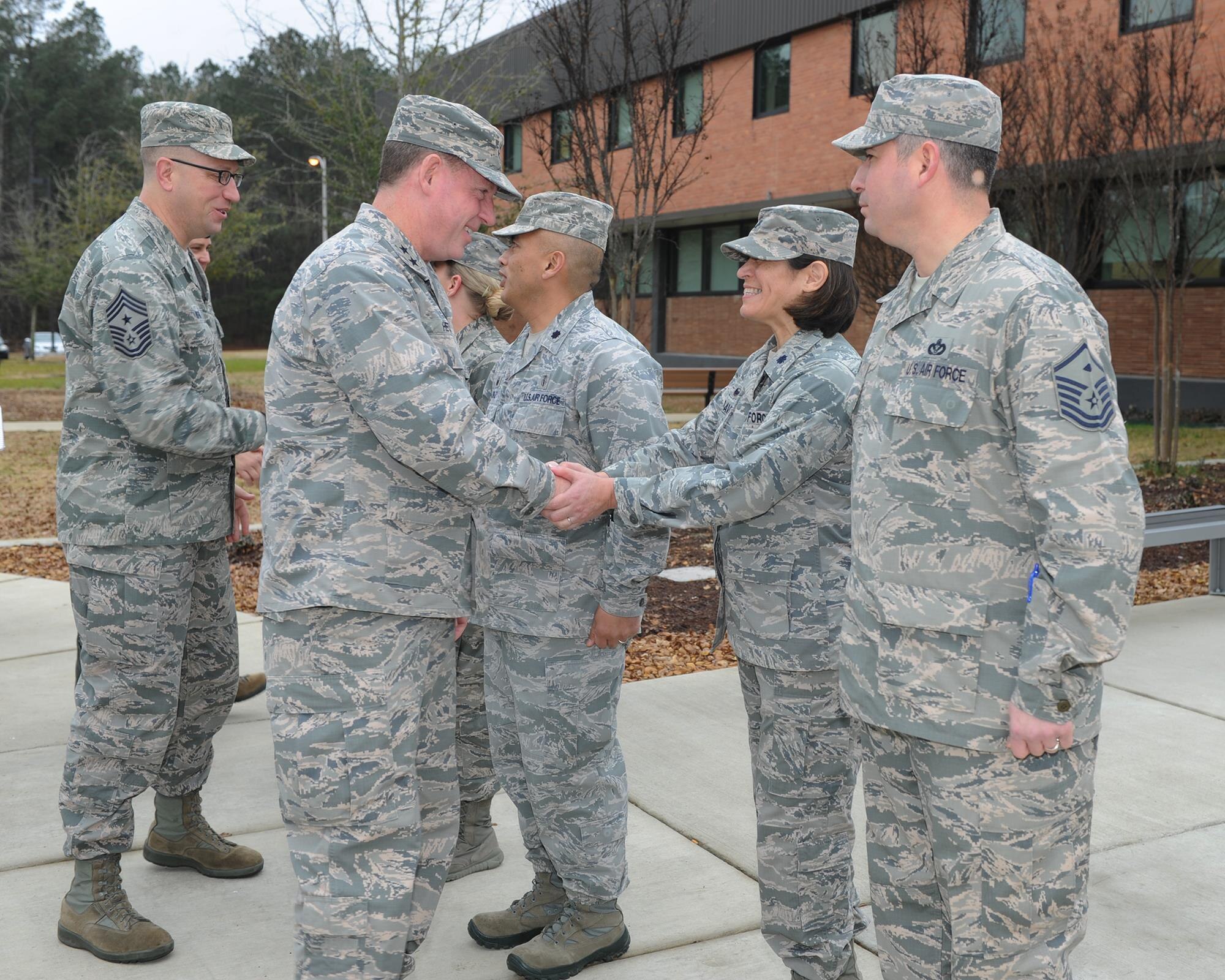 Maj. Gen. James Hecker, 19th Air Force Commander, and Chief Master Sgt. Robert Boyer, 19th AF Command Chief, shake hands with 14th Medical Group senior leadership Jan. 20 during their tour of Columbus Air Force Base, Mississippi. Hecker and Boyer met with members of the 14th Flying Training Wing and toured facilities at Columbus. (U.S. Air Force photo/Elizabeth Owens)