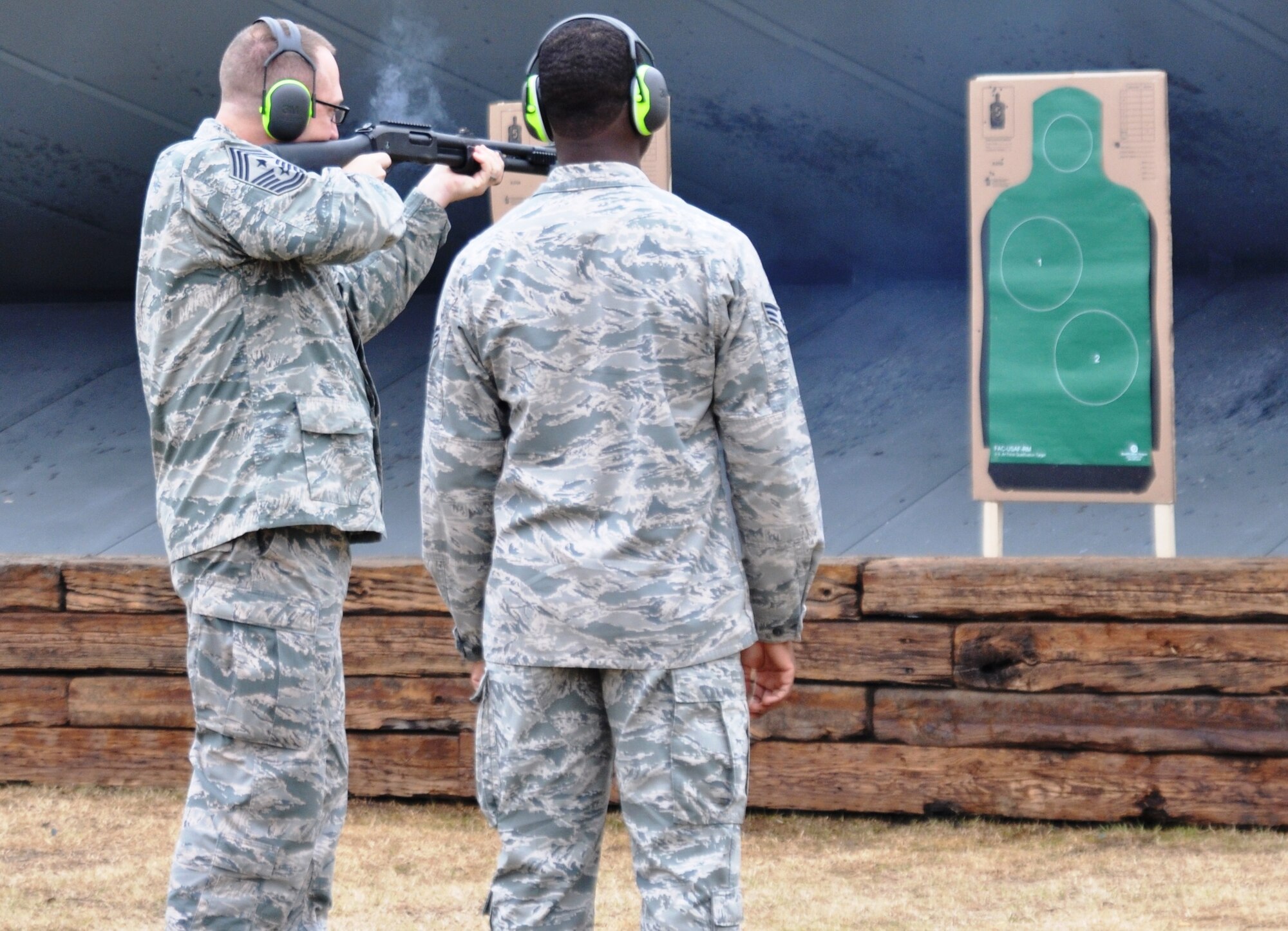Chief Master Sgt. Robert Boyer, 19th Air Force Command Chief, fires at the Columbus Lowndes County Small Arms Range in Columbus, Mississippi, Jan. 21 alongside a Columbus Air Force Base Airman during his visit to the base Jan. 20-21. During his visit, he interacted with enlisted Airmen at several venues including lunch, the tower and the clinic. (U.S. Air Force photo/Richard Johnson)
