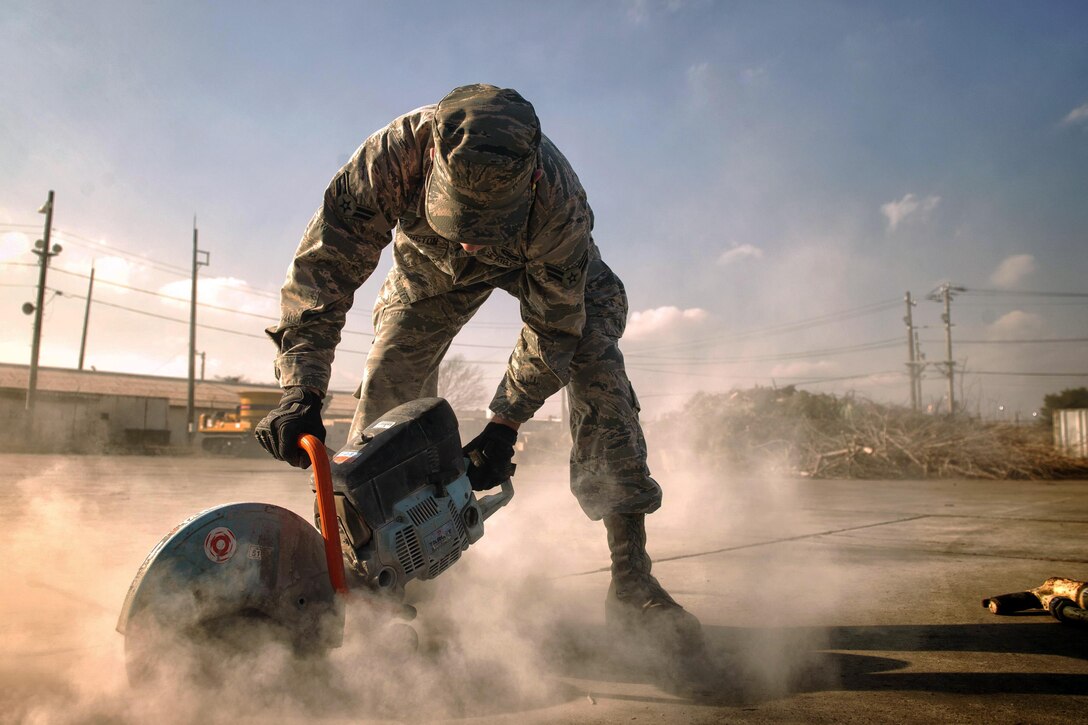 U.S. Airman 1st Class Connor Harrington performs a repair on Yokota Air Base, Japan, Jan. 13, 2016. Harrington, a 374th Civil Engineer Squadron pavement and equipment apprentice, is part of a team of airmen known as “Dirt Boys” on the base because of the work they do, from keeping the flightline ready to maintaining roads and sidewalks. U.S. Air Force photo by Airman 1st Class Delano Scott
