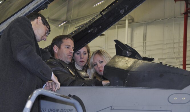 NAVAL AIR STATION FORT WORTH JOINT RESERVE BASE, Texas - Maj. Brett Comer, 457th Fighter Squadron F-16 pilot, briefs Congressional staffers, (right to left) Christen Kapavik, Caroline Thorman and Joshua Salpeter, Jan. 21 on the F-16 Fighting Falcon combat capability. The Air Force Reserve-led group visited the 301st Fighter Wing and toured its Explosive Ordnance Disposal assets and engine shop on Naval Air Station Fort Worth Joint Reserve Base, Texas. The tour’s purpose served to inform Capitol Hill defense staffers of the Reserve component’s value and contributions. (U.S. Air Force photo by Ms. Julie Briden-Garcia)