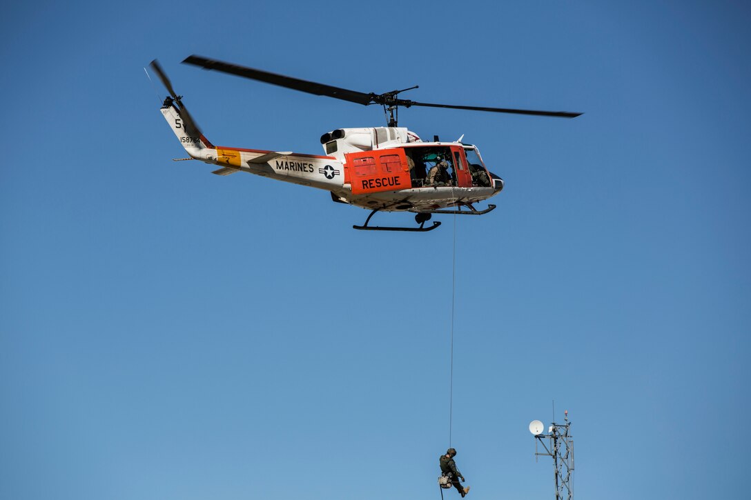 Hospital Corpsman 3rd Class Alexander Camacho, a corpsman with the Headquarters & Headquarters Squadron search and rescue section at Marine Corps Air Station Yuma, Ariz., rappelled out of a UH-1N Huey helicopter to deliver the ceremonial sword during a celebration of the Marine Corps’ 240th birthday aboard the MCAS Yuma parade field, Friday, Nov. 6, 2015.