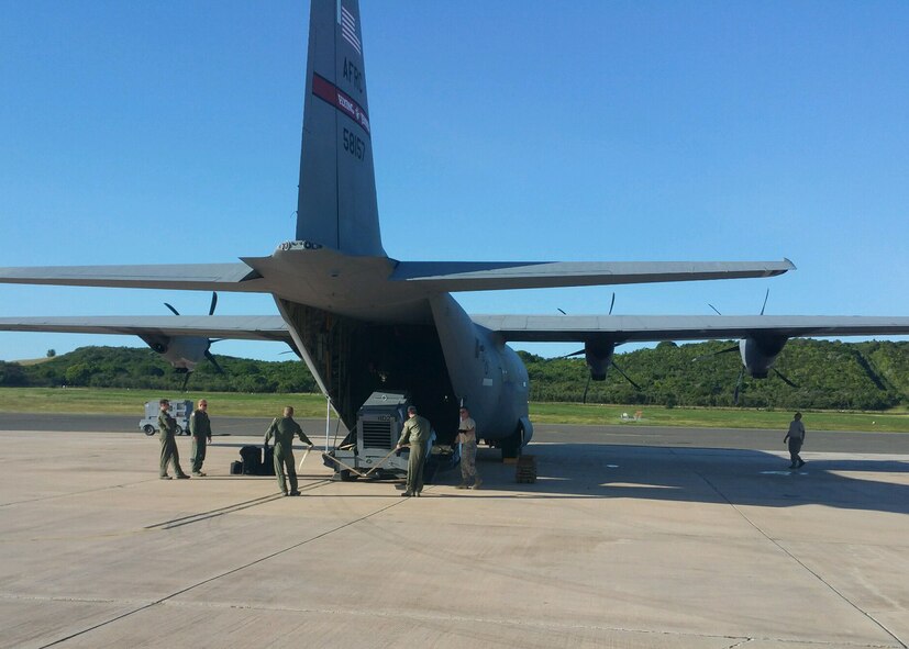 Air Force reservists with the 403rd Wing, based at Keesler Air Force Base, Mississippi, load an 815th Airlift Squadron C-130J with equipment as part of the “Roll Up” Jan. 10-17, 2016 at the Henry Rohlsen Airport in St. Croix, U.S. Virgin Islands. The airport is the forward operating base for the 53rd Weather Reconnaissance Squadron “Hurricane Hunters.” (U.S. Air Force photo/Master Sgt. Brian J. Lamar)
