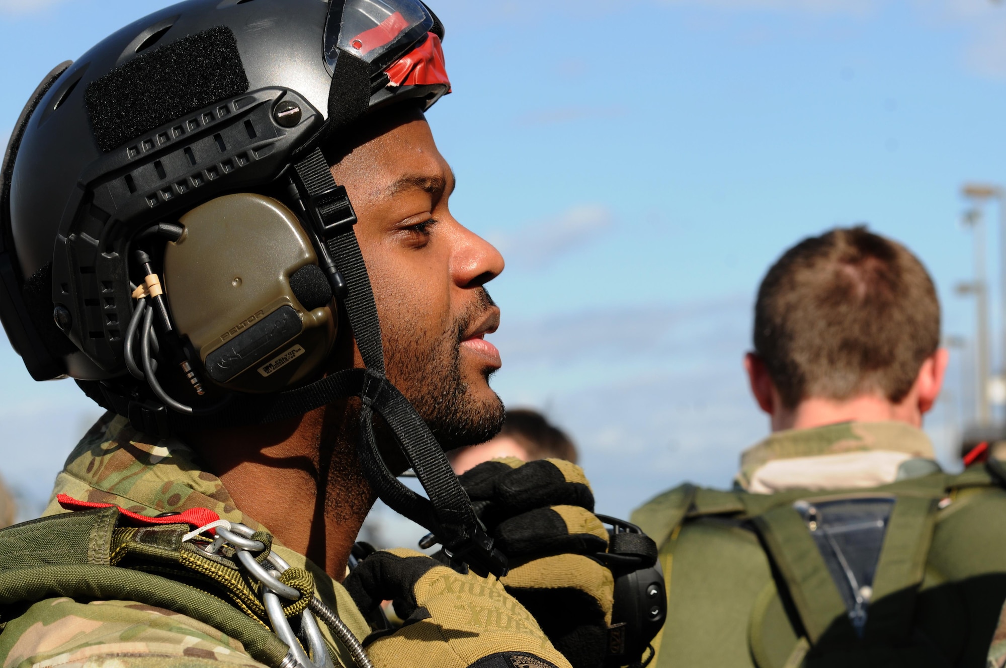 Master Sgt. Fred Demming, 335th Training Squadron special operations weather instructor, fastens his helmet prior to a parachute jump Jan. 20, 2016, Keesler Air Force Base, Miss. Keesler’s battlefield Airmen instructors periodically perform the routine training exercise to maintain their proficiency. (U.S. Air Force photo by Kemberly Groue)