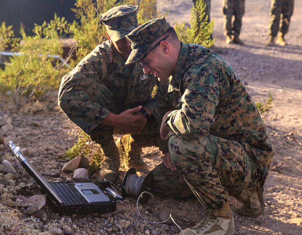 Staff Sgt. Ian Swain (left) and Staff Sgt. Joseph Witte (right), explosive ordnance disposal technicians with Headquarters and Headquarters Squadron, based out of Marine Corps Air Station Yuma, analyze an X-ray of an improvised explosive device during a training exercise at the Barry M. Goldwater Range in Yuma, Ariz., Tuesday, Dec. 8, 2015.