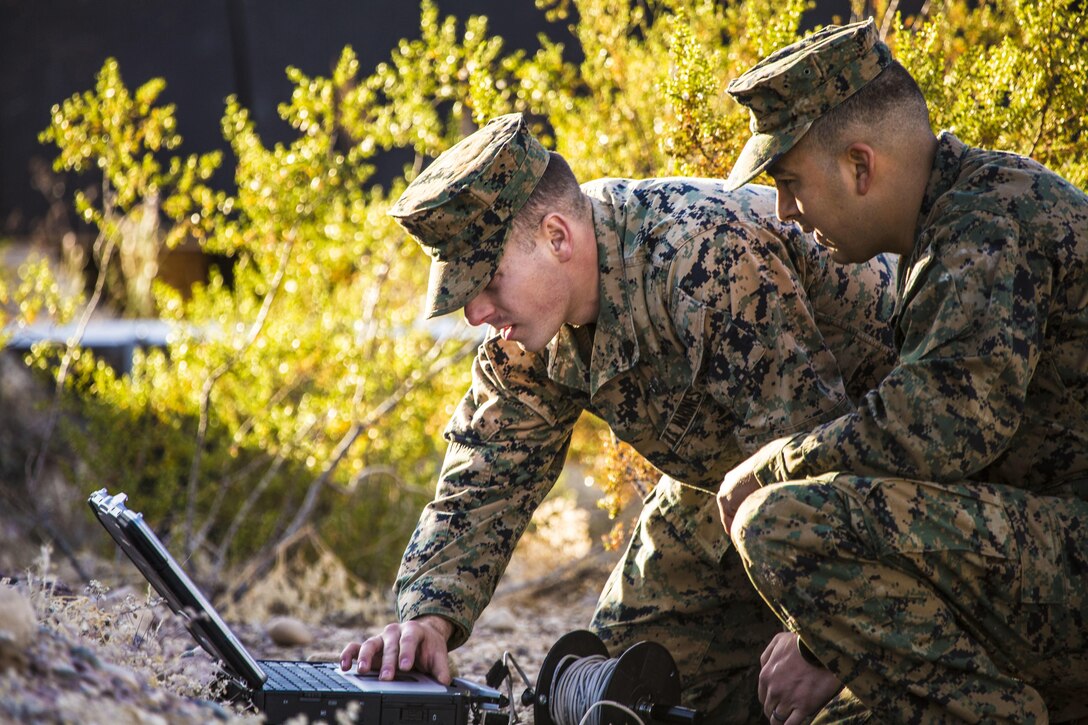 Sgt. Andrew Barnum (left) and Staff Sgt. Danny Salazar (right), explosive ordnance disposal technicians with Headquarters and Headquarters Squadron, based out of Marine Corps Air Station Yuma, analyze an X-ray of an improvised explosive device during a training exercise at the Barry M. Goldwater Range in Yuma, Ariz., Tuesday, Dec. 8, 2015.