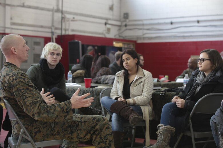 Staff Sgt. Justin Reese, maintenance chief, 24th Marine Regiment, 4th Marine Division, Marine Forces Reserve speak to Columbia College Chicago students about the global war on terrorism during an informal discussion at their training center in Chicago, Jan. 20, 2016. During the event, the Marines and students were separated into small groups where they began to talk and share personal stories and experiences about their military career. Many Americans, like the majority of these students, do not have regular interactions with Marines. As the most geographically dispersed command in the Marine Corps, however, Marine Forces Reserve is uniquely positioned to have these kinds of community interactions.