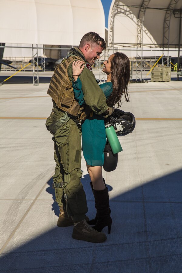 Capt. Phil Smith, an AV-8B Harrier pilot with Marine Attack Squadron 311, based out of Marine Corps Air Station Yuma, reunites with his wife at the VMA-311 hangar aboard MCAS Yuma, Ariz., Saturday, Dec. 11, 2015. VMA -311 was on a six-month deployment in support of the 15th Marine Expeditionary Unit.