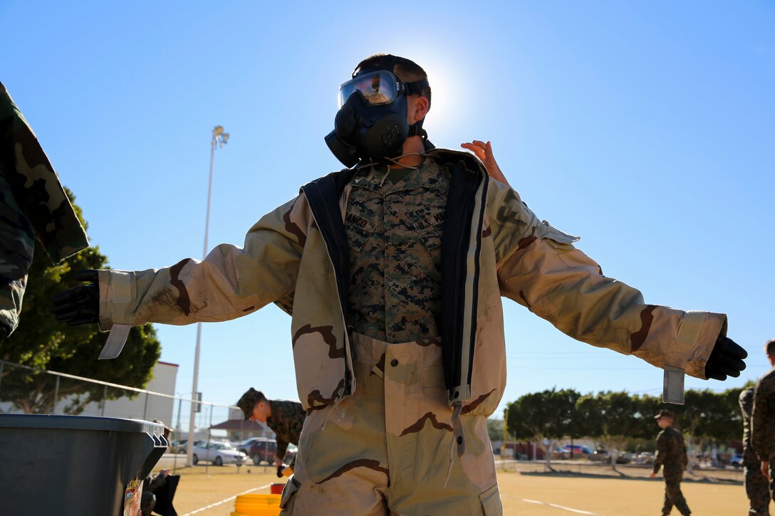Marines with Marine Wing Support Squadron 371 don Mission Oriented Protective Posture (MOPP) suits and gas masks during Chemical, Biological, Radiological and Nuclear (CBRN) decontamination and reconnaissance training aboard Marine Corps Air Station Yuma, Ariz., Jan. 13, 2016.