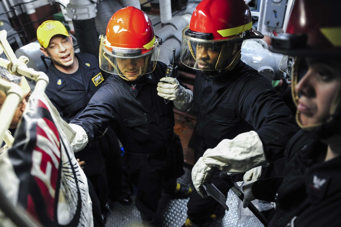 Sailors simulate applying an emergency repair patch to a pipe in the auxiliary machinery room of the USS Boxer during a drill in the Pacific Ocean, Jan. 20, 2016. Personnel aboard the Boxer are conducting routine training and maintenance to prepare for an upcoming deployment. U.S. Navy photo by Petty Officer 3rd Class Michael T. Eckelbecker