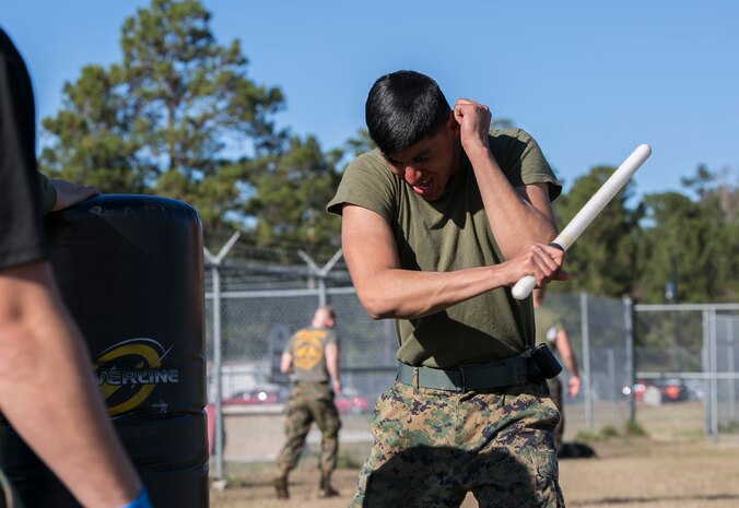 A Marine with Combat Logistics Battalion 22 attacks a stationary punching bag with a baton after being sprayed in the eyes with oleoresin capsicum, more commonly known as OC spray, at Camp Lejeune N.C., Jan 14. CLB-22 Marines have been enrolled in the course for a week and have started studying the effects and purposes of OC spray. Marines often use OC spray when mechanical control holds or other take down techniques are no longer safe to execute. (U.S. Marine Corps photo by Lance Cpl. Luke Hoogendam/Released)