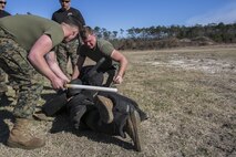 Lance Cpl. Hunter Rooks, left, and Lance Cpl. Joshua Sutton, both Marines with Combat Logistics Battalion 22, perform a two man take-down against an armed aggressor after being sprayed in the eyes with oleoresin capsicum, more commonly known as OC spray, at Camp Lejeune N.C., Jan 14. The take-down was part of an obstacle course, which also entailed the use of other baton techniques, blocking attacks from an assailant and a two-man takedown against an armed aggressor. (U.S. Marine Corps photo by Lance Cpl. Luke Hoogendam/Released)