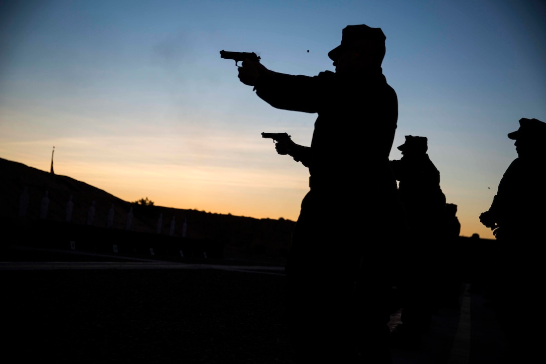 Marines stationed out of Marine Corps Air Station Yuma, Ariz., engage in firearms training and qualification at the station pistol range, Wednesday, Jan. 20, 2016.