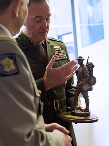 U.S. Marine Corps Gen. Joseph F. Dunford Jr., right, chairman of the Joint Chiefs of Staff, presents a bronze statue of an American soldier from World War I to Gen. Pierre de Villiers, chief of France's defense staff, at the French defense headquarters in Paris, Jan. 22, 2016. DoD photo by D. Myles Cullen