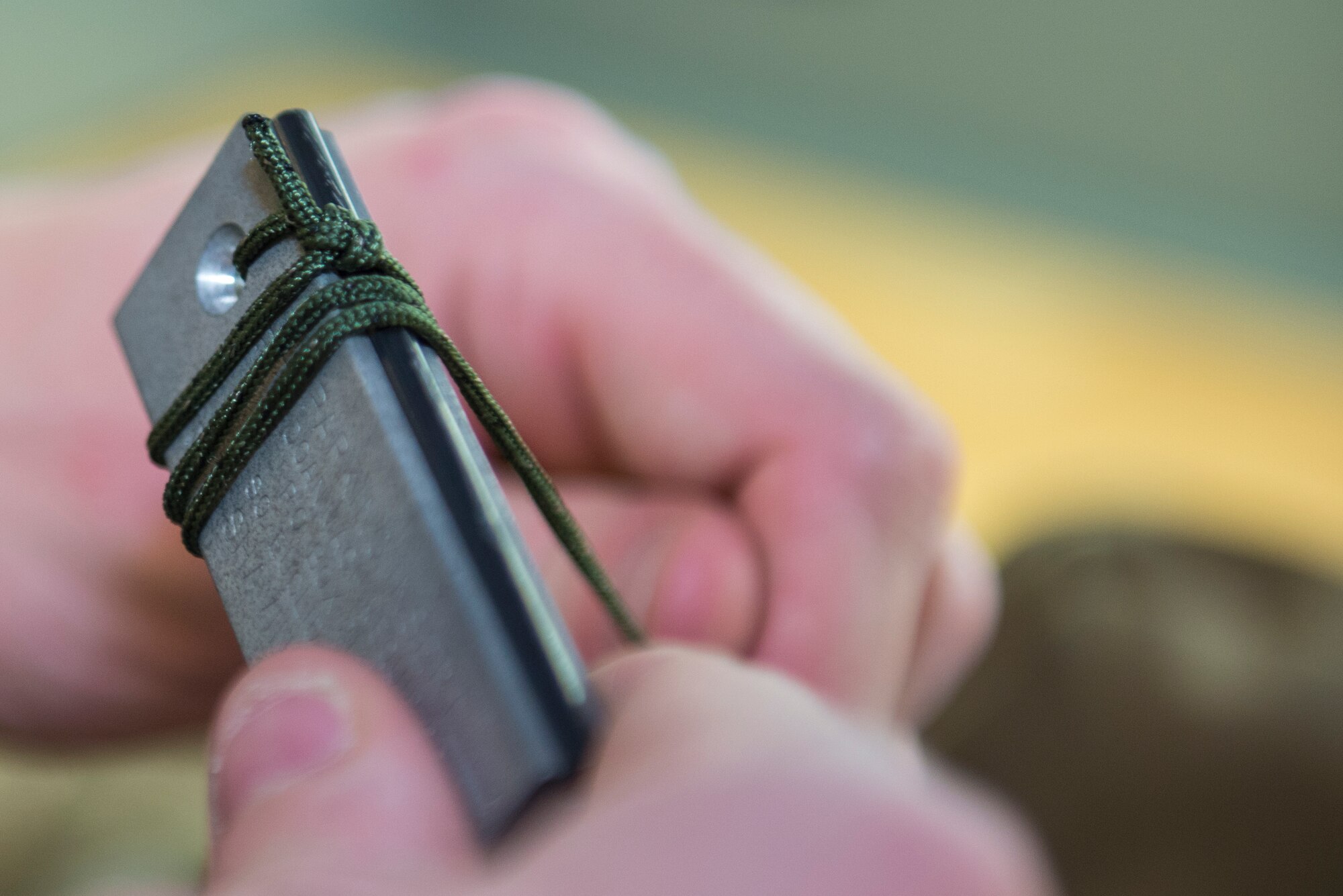 U.S. Air Force Senior Airman Logan Caldwell, 23d Operations Support Squadron aircrew flight equipment journeyman, wraps a flint strike heating device prior to insertion in an Air Ace Survival vest, Jan. 22, 2016, at Moody Air Force Base, Ga. AFE life support technicians inspect the vest approximately every 180 days at home station and every 60 days in combat zones. (U.S. Air Force photo by Airman 1st Class Greg Nash/Released)