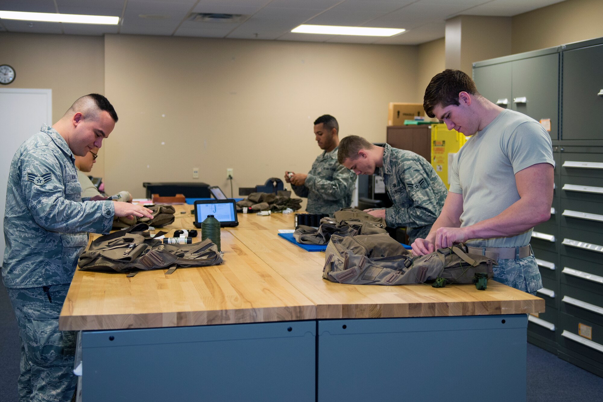 Members of the 23d Operations Support Squadron’s aircrew flight equipment life support section inspect and reconfigure Air Ace Survival vests, Jan. 22, 2016, at Moody Air Force Base, Ga. AFE life support technicians are responsible for maintaining and inspecting the 23d Fighter Group’s A-10C Thunderbolt II pilot’s flight equipment. (U.S. Air Force photo by Airman 1st Class Greg Nash/Released)