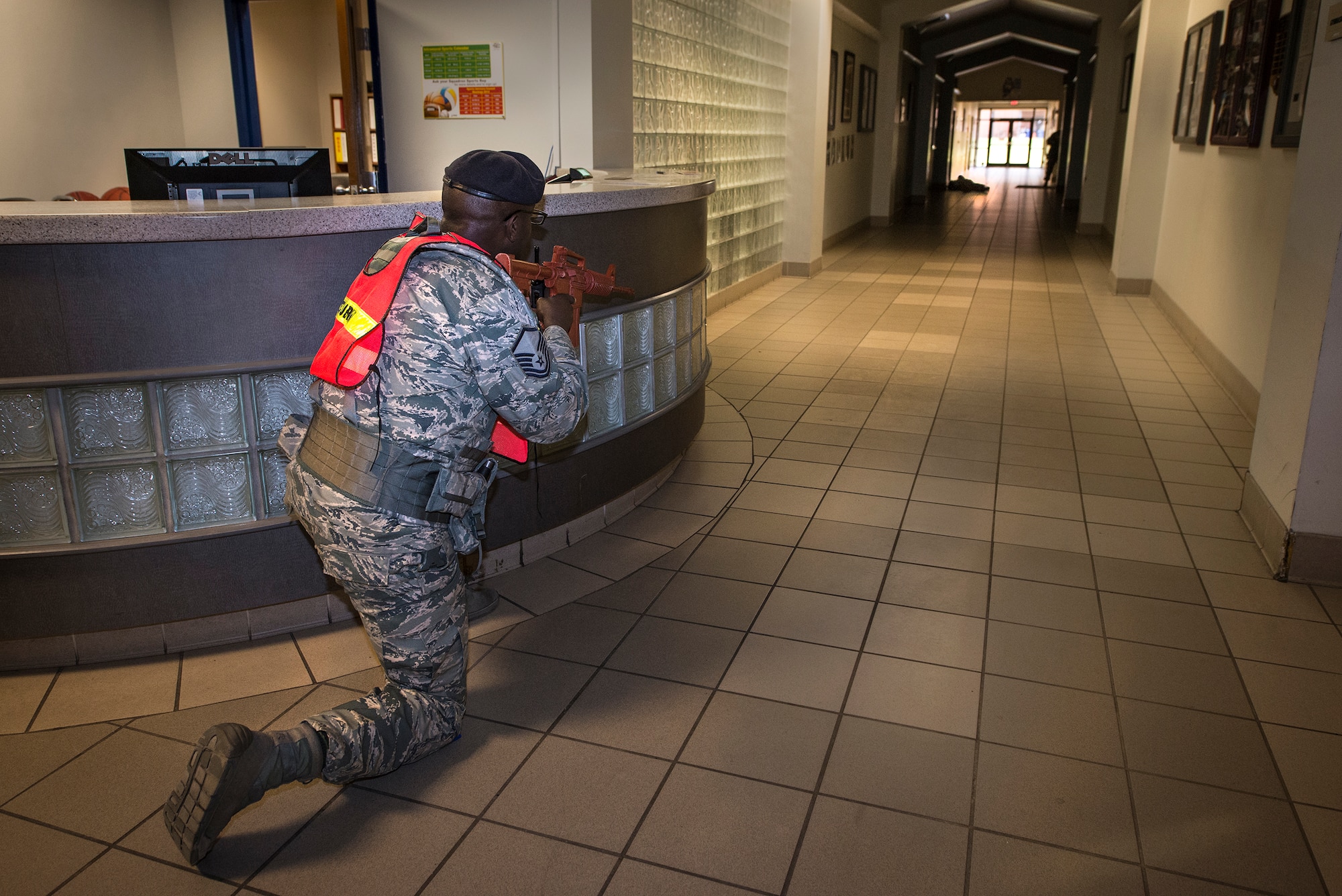 U.S. Air Force Master Sgt. Anthony Lawrence, 23d Security Forces Squadron flight chief, keeps aim after shooting down the gunman during an active shooter exercise, Jan. 21, 2016, at Moody Air Force Base, Ga. The 23d Wing performs training exercises annually in order to ensure all Moody personnel know how to respond to maintain maximum safety on base. (U.S. Air Force photo by Airman 1st Class Lauren M. Johnson/Released)