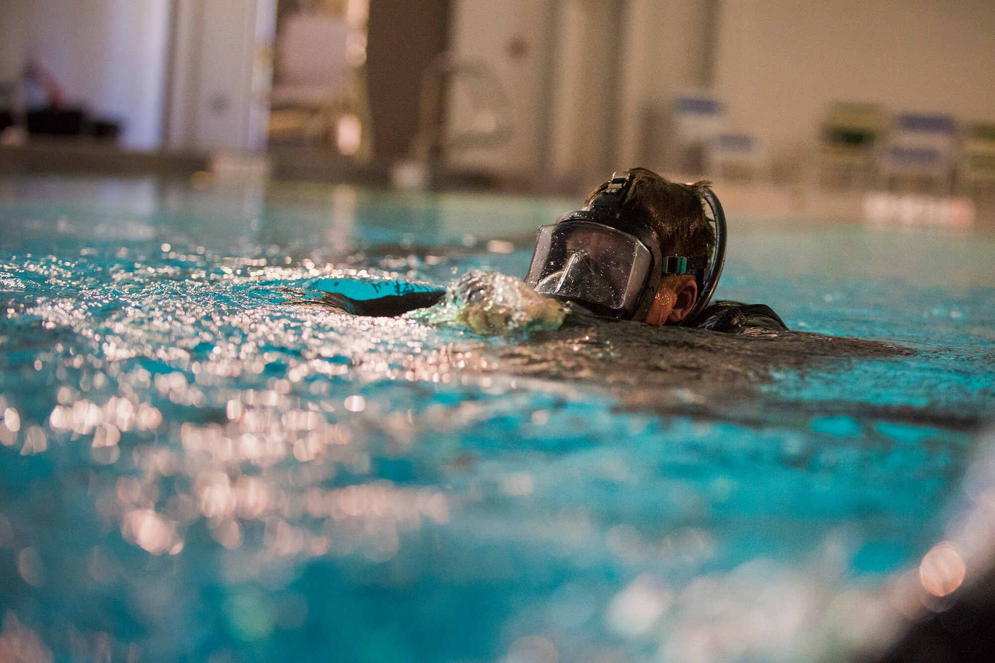 U.S. Air Force Capt. Levi Cass, 38th Rescue Squadron combat rescue officer, surfaces from his qualifying dive, Jan. 20, 2016, at Moody Air Force Base, Ga. Airmen wear drysuits to protect against anything toxic or dangerous they could encounter during a water search and rescue mission. (U.S. Air Force photo by Airman Daniel Snider/released)