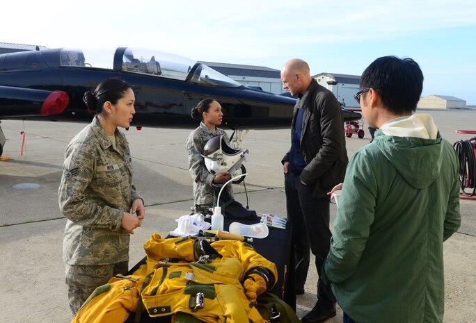 Senior Airman Soreya Moun (left), and Senior Airman Christian Mitchell, 9th Physiological Support Squadron full-pressure suit technicians, conduct a suit demonstration for media representatives Jan. 21, 2016, at Beale Air Force Base, California. Several media outlets were invited to a DreamWorks Pictures “Bridge of Spies” DVD event. (U.S. Air Force photo by Senior Airman Bobby Cummings)