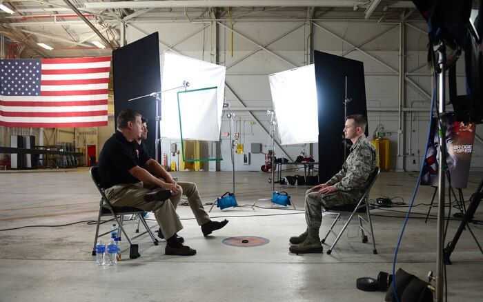 Airman 1st Class Benjamin Bugenig (right), 9th Reconnaissance Wing broadcast journalist, interviews Austin Stowell , the actor who portrayed Francis Gary Powers, in the film Bridge of Spies, and Francis Gary Powers Jr., Jan. 21, 2016, at Beale Air Force Base, California. DreamWorks Pictures returned to film DVD extra footage for the movie, which featured the U-2 Dragon Lady and was partly filmed at Beale. (U.S. Air Force photo by Senior Airman Bobby Cummings)