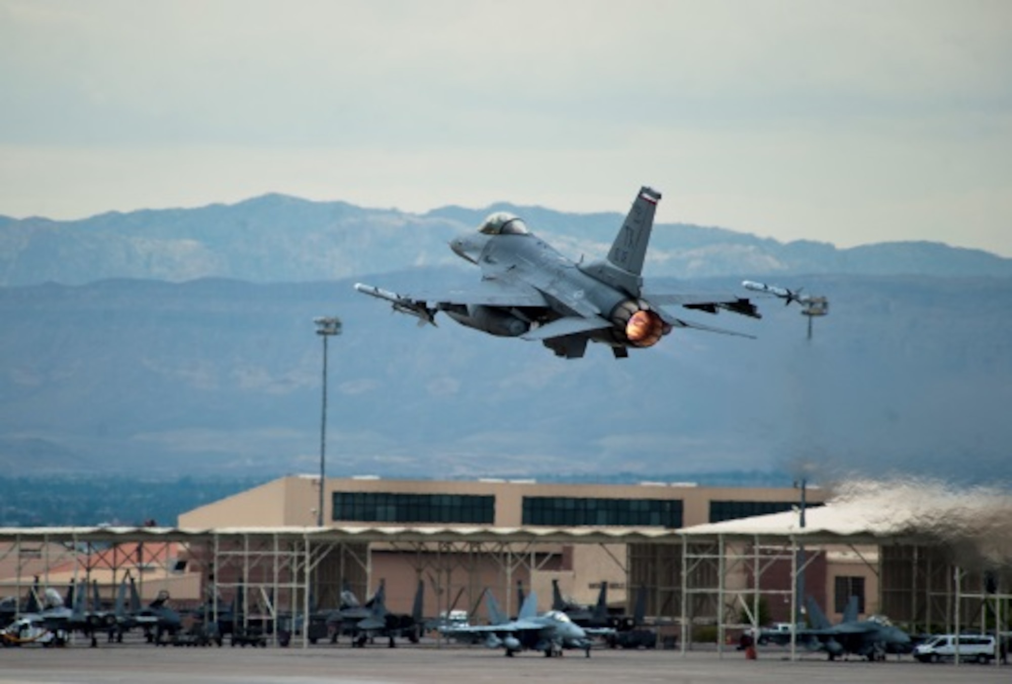 An F-16 Fighting Falcon assigned to the 457th Fighter Squadron, Naval Air Station Fort Worth Joint Reserve Base, Texas, takes off during Red Flag 15-4 at Nellis Air Force Base, Nev., Aug. 25, 2015. All four U.S. military services, their Guard and Reserve components and the air forces of other countries participate in each Red Flag exercise. (U.S. Air Force photo by Senior Airman Thomas Spangler)