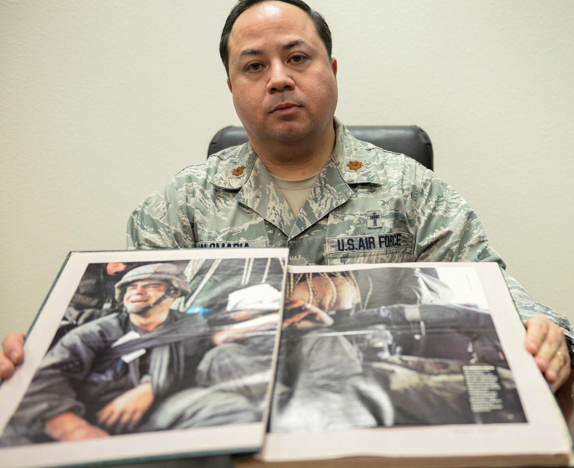 Maj. Alexander Palomaria, 366th Fighter Wing deputy chaplain, displays his scrapbook of Desert Storm-era articles and photos, Jan. 13, 2016, at Mountain Home Air Force Base, Idaho. For Palomaria, Desert Storm was the confirmation he needed to become a military chaplain. (U.S. Air Force photo by Airman 1st Class Jessica H. Evans/RELEASED)
