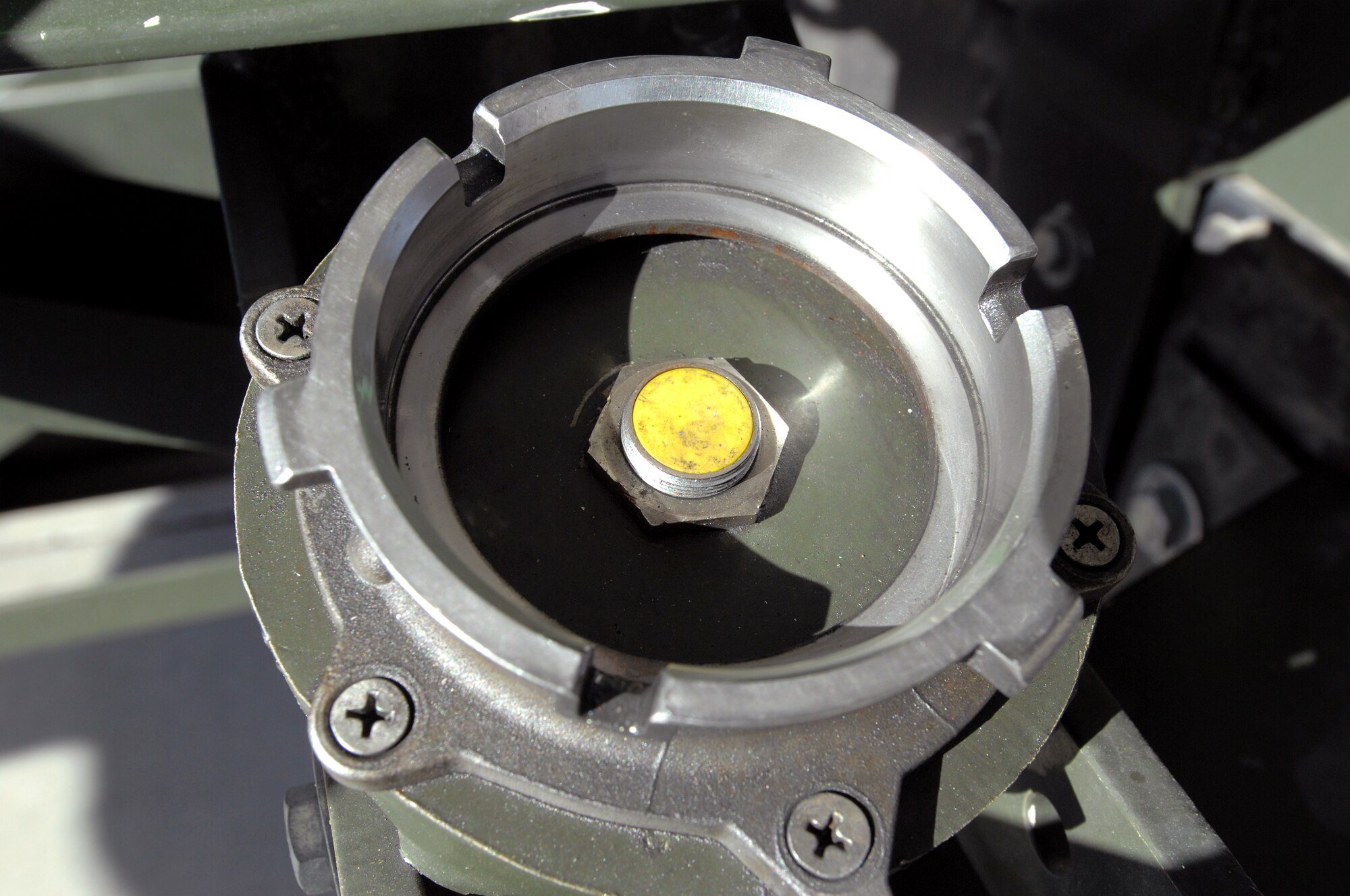 A bolt that was adjusted on R-12 Hydrant Servicing Vehicles throughout the Air Force to prevent fuel from leaking when stowing servicing hoses. (U.S. Air Force photo by Delanie Stafford/Released)