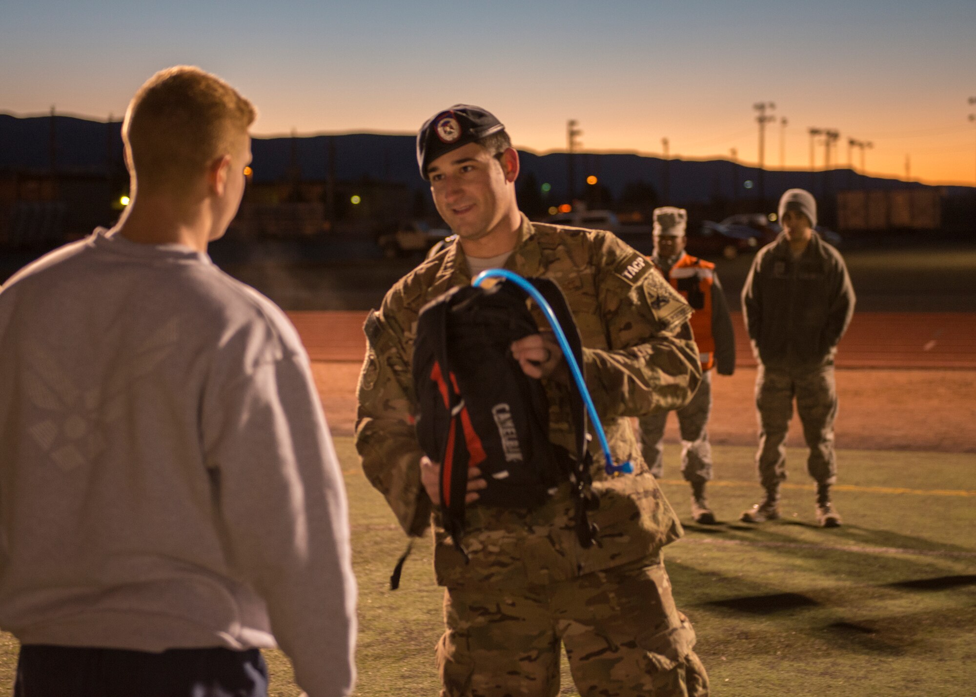 Senior Airman Neiko Guillory, a Tactical Air Control Party member from Fort Bliss, Texas, inspects an Airman’s hydration system during a Battlefield Airmen Day at Holloman Air Force Base on Jan. 15. Holloman Airmen participated in a Physical Ability and Stamina Test as well as other exercises as part of an event to test their physical and mental ability and eligibility for Air Force Special Forces jobs. “This is to show them where they stand and what training they need to progress,” said Guillory. (U.S. Air Force photo by Airman 1st Class Randahl J. Jenson) 