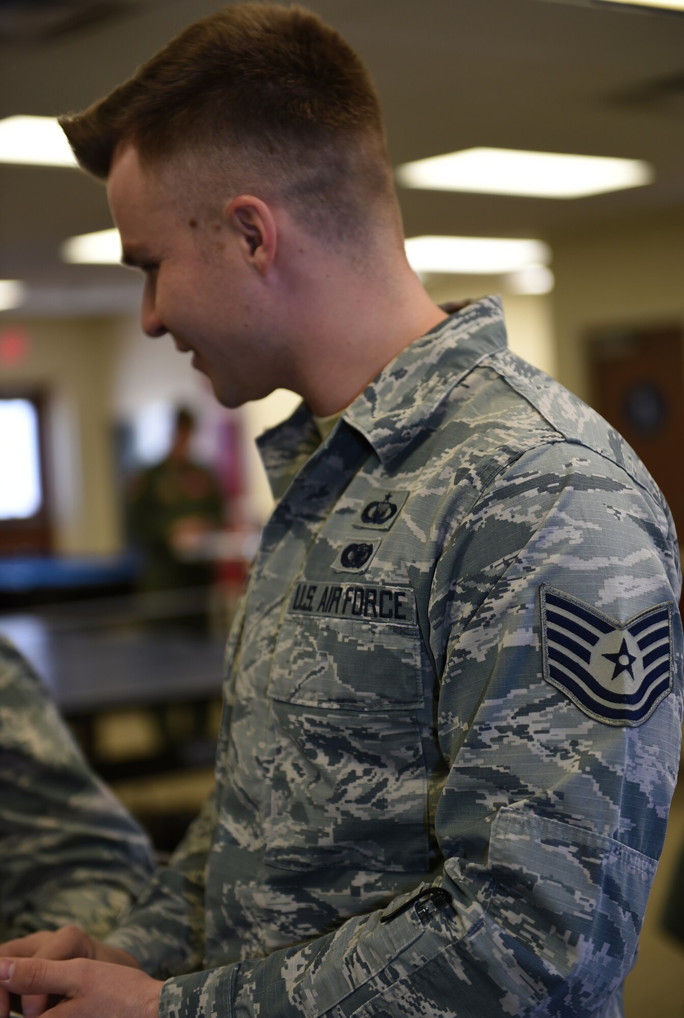 Air Force Tech. Sgt. Noah, 432nd Wing/ 432nd Air Expeditionary Wing chaplain assistant, speaks with other chapel personnel Jan. 20, 2016, at Creech Air Force Base, Nevada. Noah is the NCOIC of chapel affairs and is tasked with administrative work for the Chaplain Corps. Chaplain assistants help to provide spiritual care and opportunity for Airmen, their families, and other authorized personnel to exercise their constitutional right to the free exercise of religion. (U.S. Air Force photo by Airman 1st Class Kristan Campbell/Released)