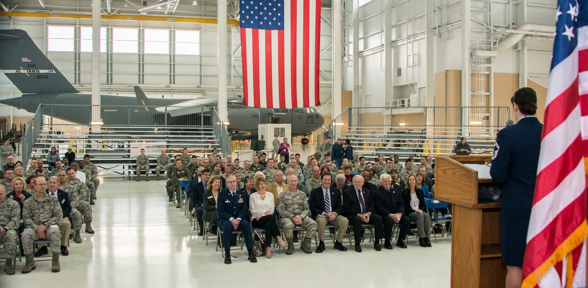 Senior Master Sgt. Veronica Ross, 60th Aerospace Medicine Squadron public health flight superintendent, speaks Jan. 19, 2016, in the hangar at building 837 during a ceremony commemorating the 50th anniversary of the 60th Air Mobility Wing, at Travis Air Force Base, California. (U.S. Air Force photo by Heide Couch)