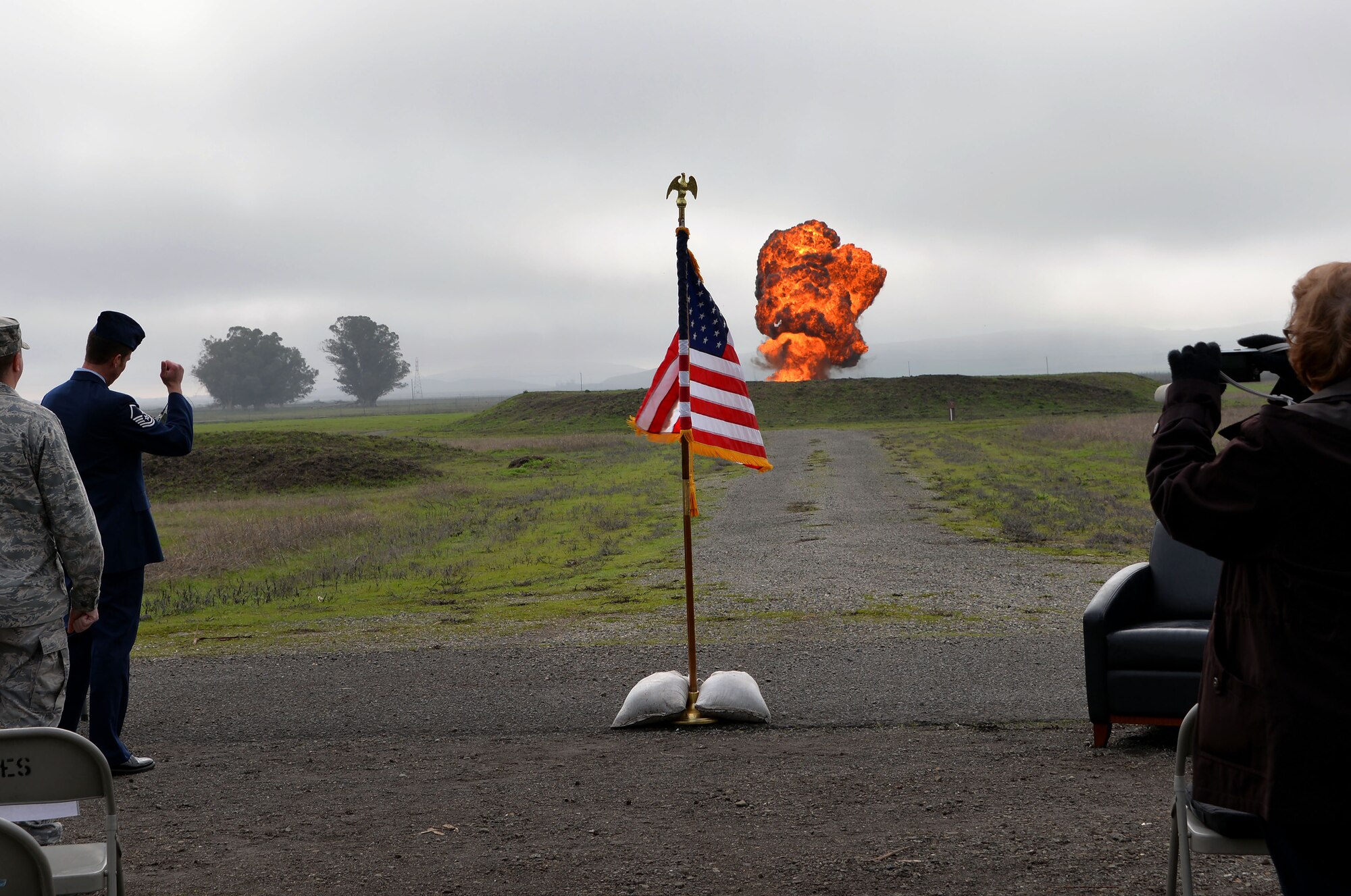 Onlookers watch the final shot during a retirement ceremony for Master Sgt. William Feil, 60th Civil Engineer Squadron explosive ordnance disposal flight chief, Jan. 15, 2016. Feil is retiring from the Air Force after more than 24 years of active-duty service. (U.S. Air Force photo by Senior Airman Charles Rivezzo)