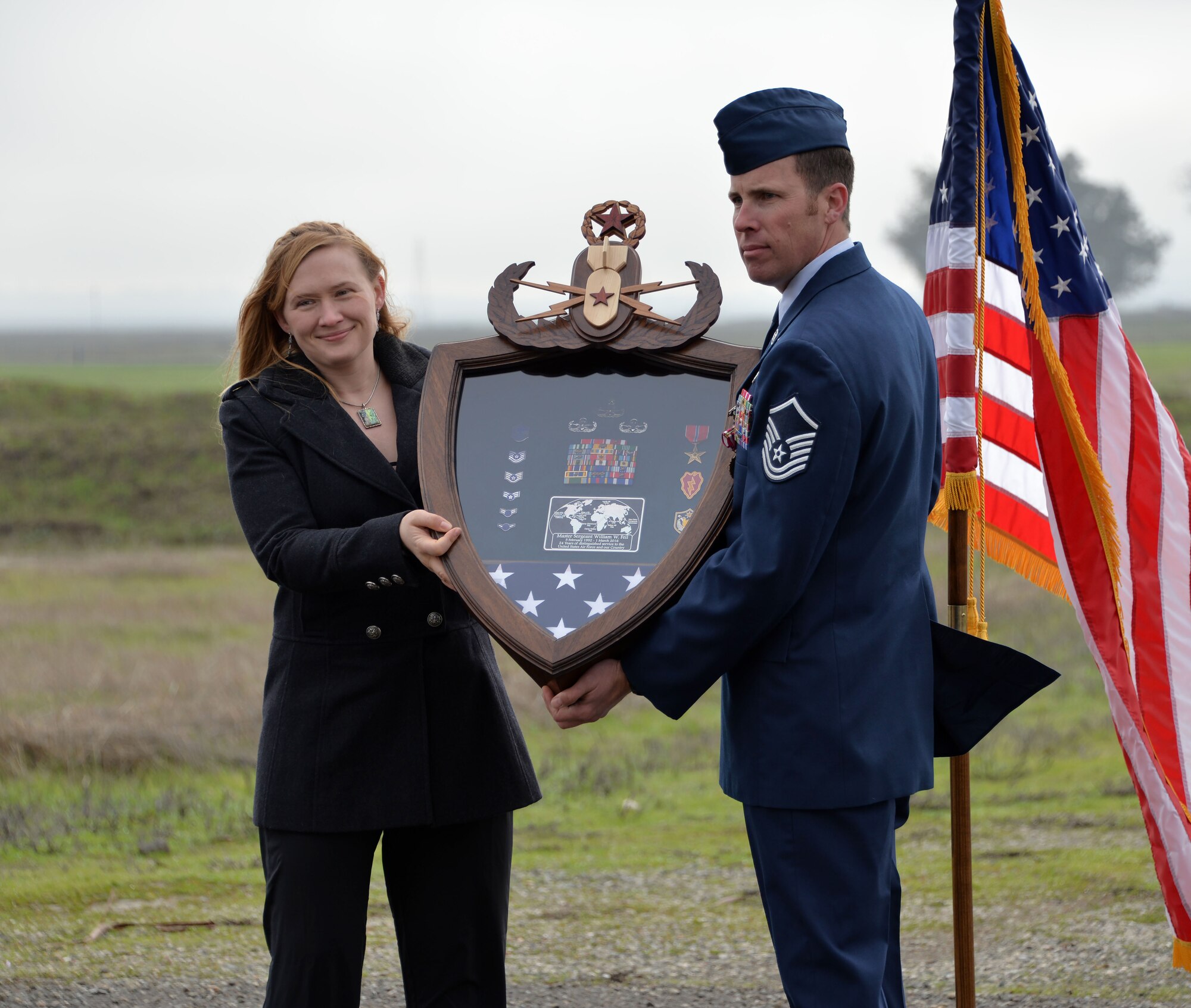Master Sgt. William Feil, 60th Civil Engineer Squadron explosive ordnance disposal flight chief, poses for a photo with his wife Jan. 15, 2016, during his retirement ceremony at Travis Air Force Base, California. Feil is retiring after more than 24 years of active-duty service. (U.S. Air Force photo by Senior Airman Charles Rivezzo)