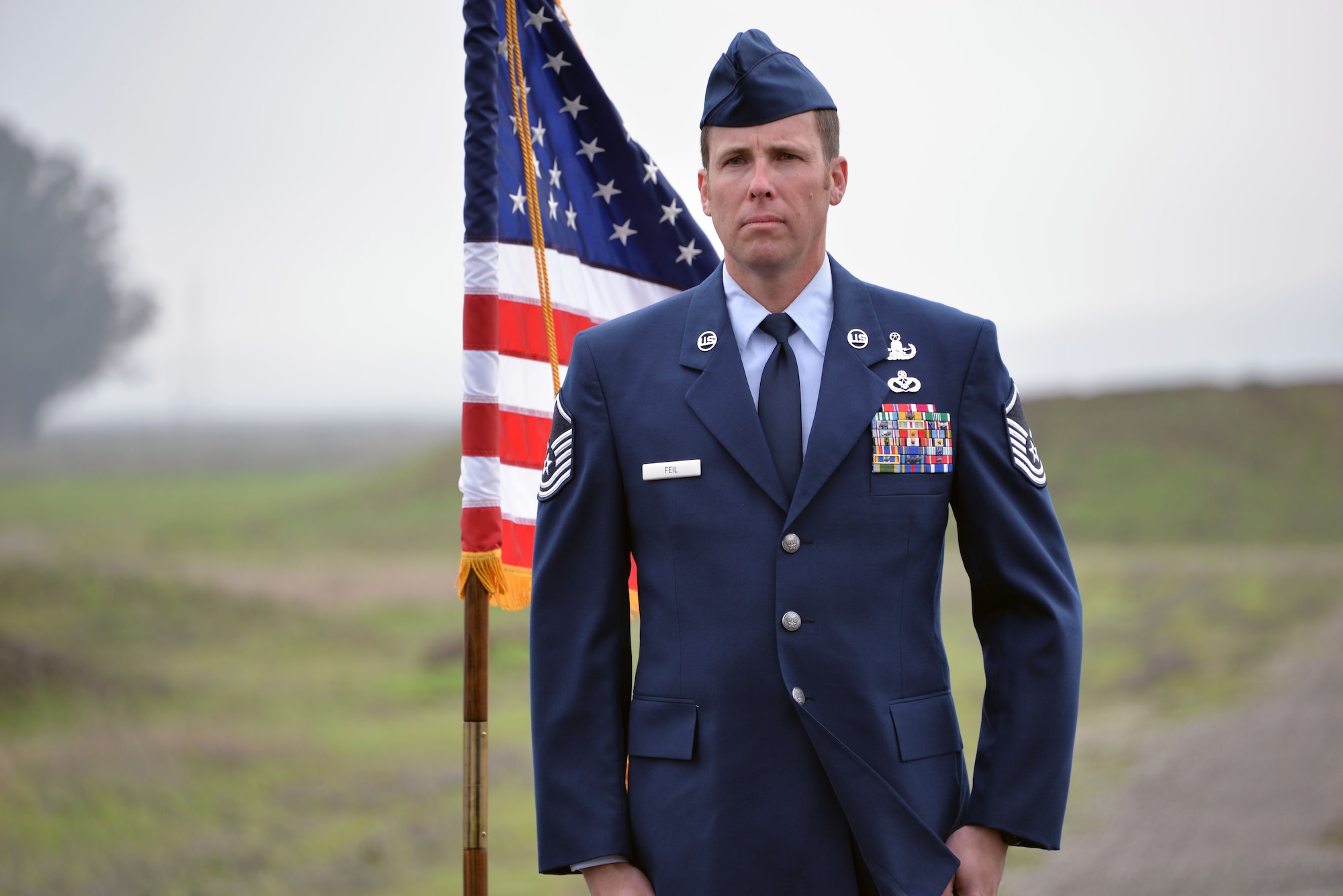 Master Sgt. William Feil, 60th Civil Engineer Squadron explosive ordnance disposal flight chief, stands at attention Jan. 15, 2016, during his retirement ceremony at Travis Air Force Base, California. Feil is retiring after more than 24 years of active-duty service. (U.S. Air Force photo by Senior Airman Charles Rivezzo)