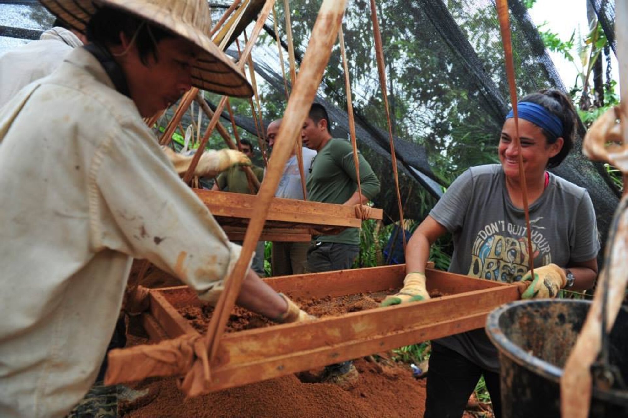 Tech. Sgt. Robin Bailon, right, 60th Operations Support Squadron, and a Vietnamese local screen dirt for evidence in hopes of finding life-support equipment and remains from a Vietnam-era crash. (Courtesy photo)
