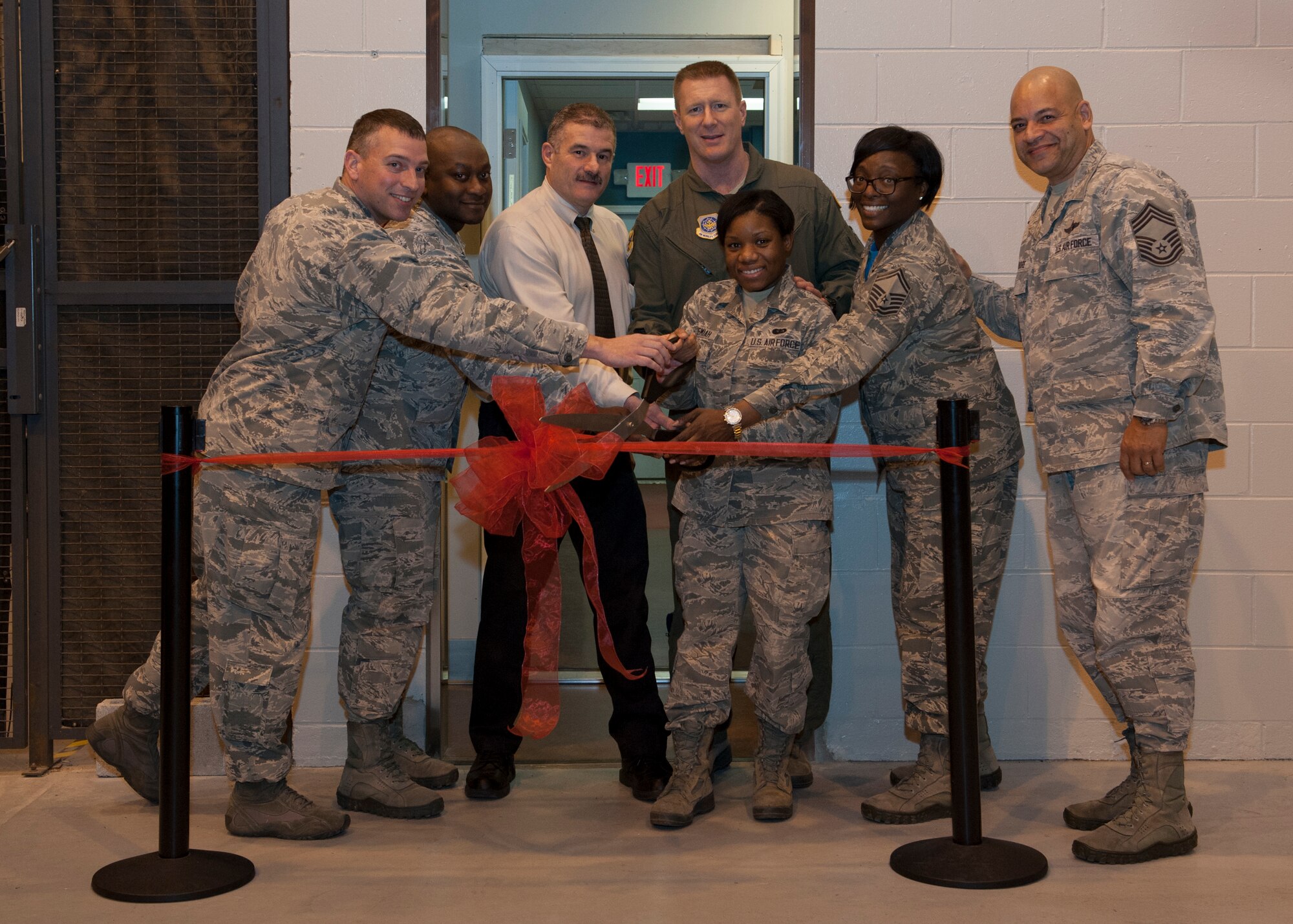 Team Dover leadership cuts the ribbon to officially open the new Heavy Lifters flight line food kiosk Jan. 15, 2016, at Dover Air Force Base, Del. Heavy Lifters offers Team Dover personnel an outlet for grab-and-go quality meals. (U.S. Air Force photo/Senior Airman Zachary Cacicia)