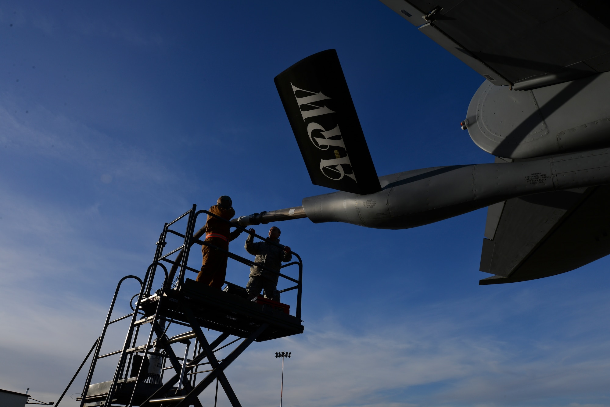 U.S. Air Force Staff Sgt. Karl Asuncion, 100th Maintenance Group jets quality assurance inspector, asks U.S. Air Force Airman 1st Class Adrian Pinnock, 100th Aircraft Maintenance Squadron KC-135 Stratotanker crew chief, a question Jan. 13, 2016, on the flightline on RAF Mildenhall, England. Quality assurance inspectors perform personnel evaluations to monitor the maintainers’ ability to conduct specific maintenance tasks while following technical orders and safety standards. (U.S. Air Force photo by Staff Sgt. Micaiah Anthony/Released)